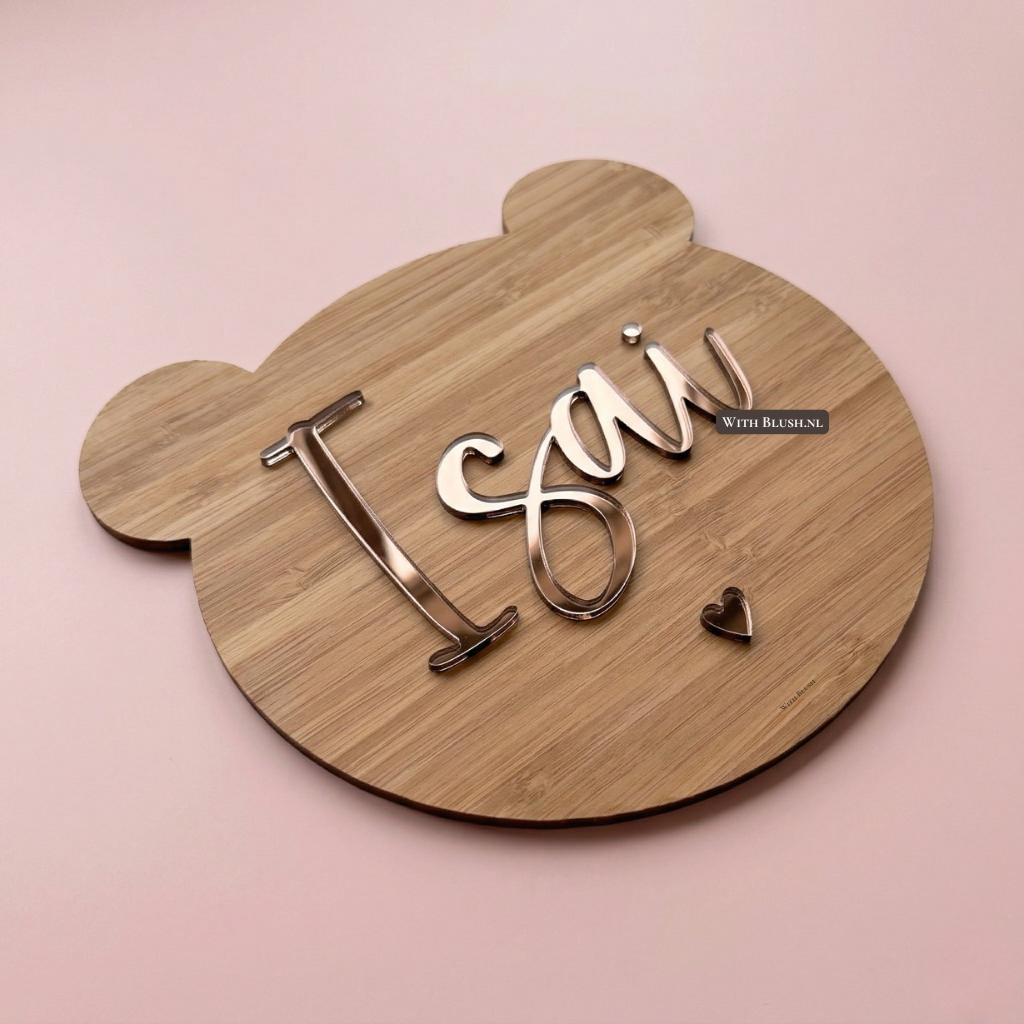 Bamboehout teddybeer naambord in met brons spiegelletters, hartje en de naam Isai van acryl plexiglas